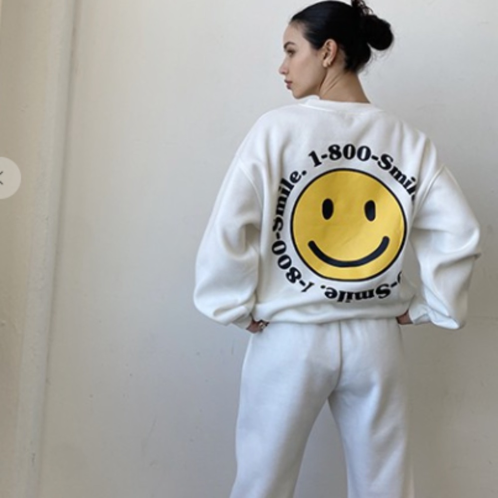 White sweatshirt with smile graphic